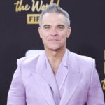 Robbie Williams says he's "Bruce Wayne in Los Angeles and Batman everywhere else”