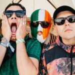 Kneecap pledge to give sales profits to charity as they score highest chart position for Irish language album with ‘Fenian’ landing at Number Two in UK