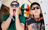 Kneecap pledge to give sales profits to charity as they score highest chart position for Irish language album with ‘Fenian’ landing at Number Two in UK
