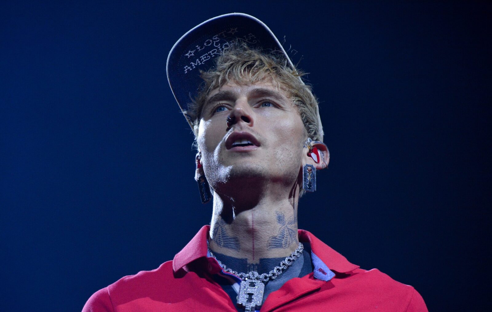 Watch MGK "mess my back up really, really bad" as he somersaults off roof into audience